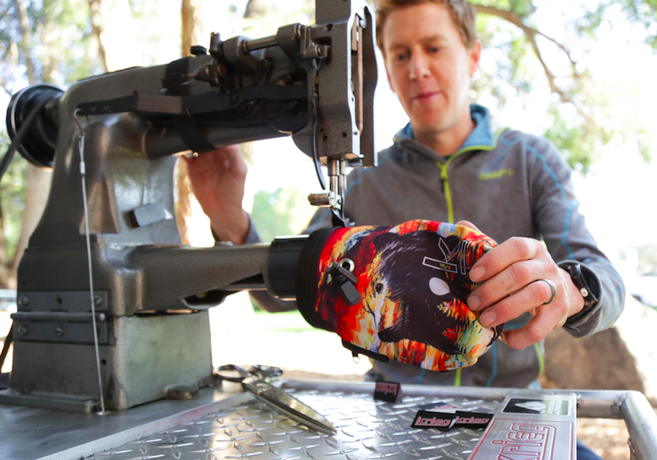 An individual sews a climbing bag.