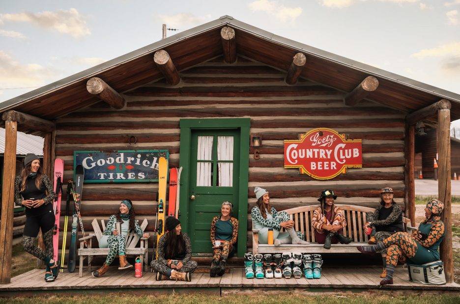 A group of women chat as they wear Wild Rye gear.