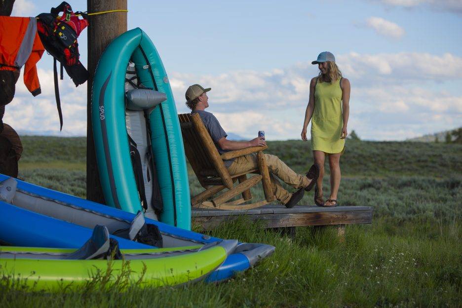 A group hangs out outside near AIRE whitewater rafts.