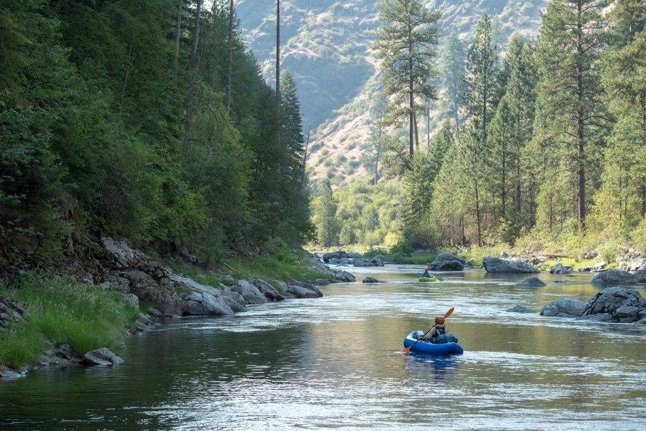 A kayaker sits in an Idaho river.