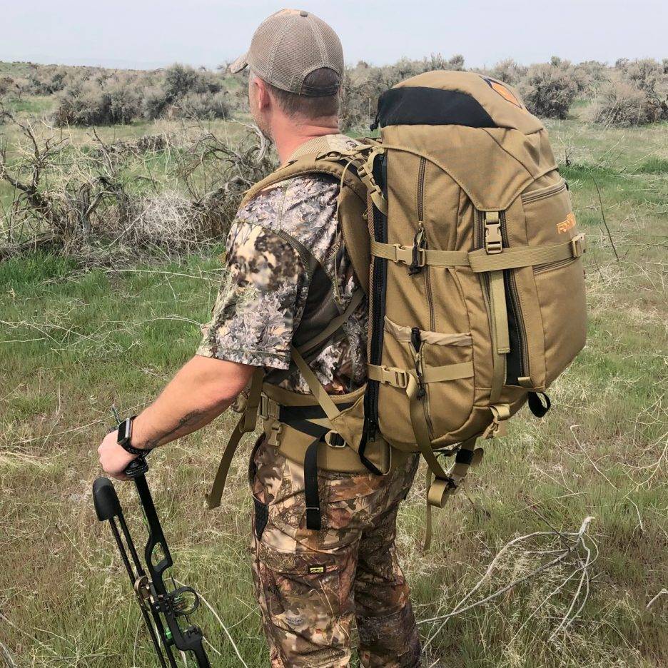 Outdoorsman standing with BC Guide Gear pack