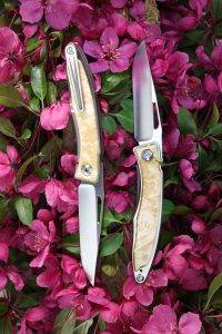 Pocket knife lays in pink flowers