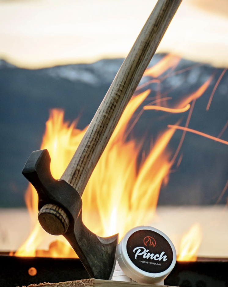 A pinch outdoors product sits in front of a fire.