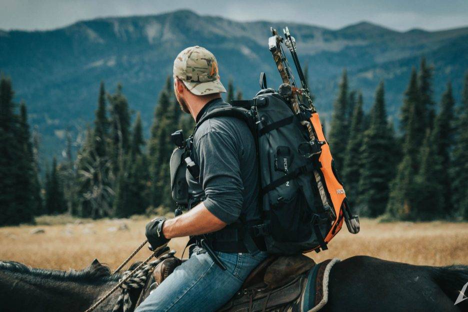 Man riding a horse with ROKMAN pack on his back