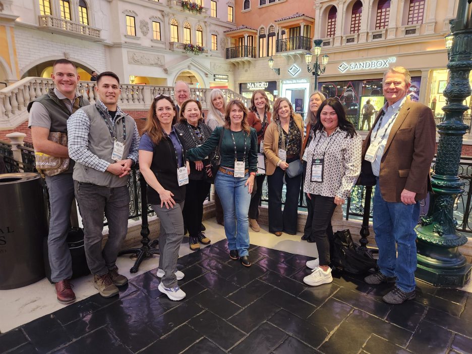 Gov. Brad Little poses with SHOT Show attendees
